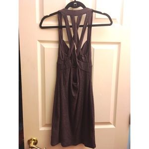 Purple strappy open back dress form fitting.